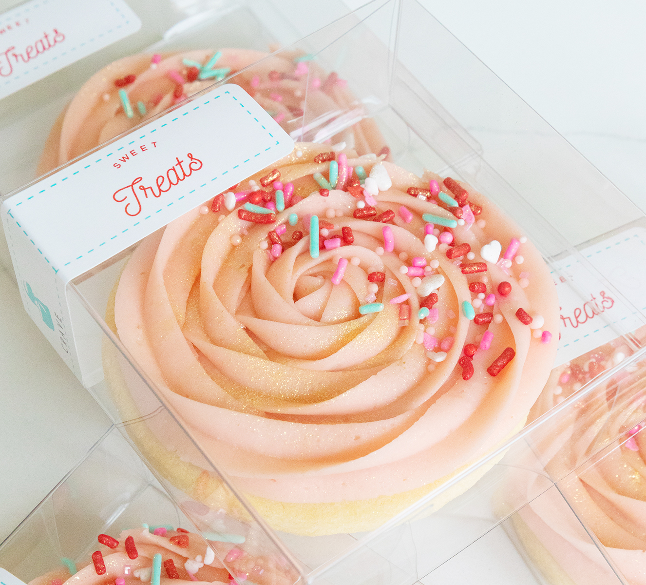 We bake our cupcakes fresh daily. (Shown: Valentine's Day Pink Rosette Sugar Cookie cupcakes.)